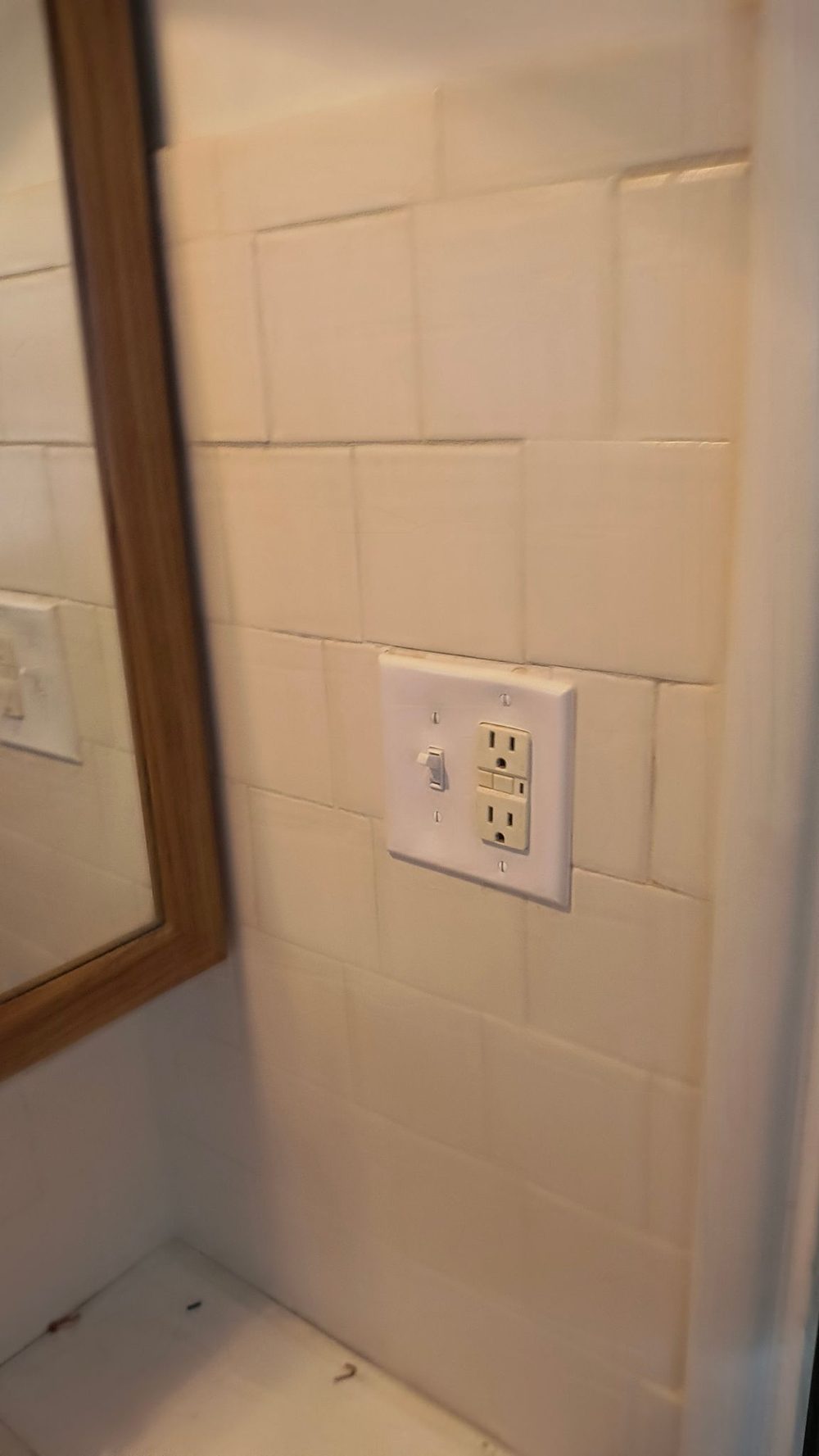 Finish work from a recent remodel — clean device installation in fresh tile